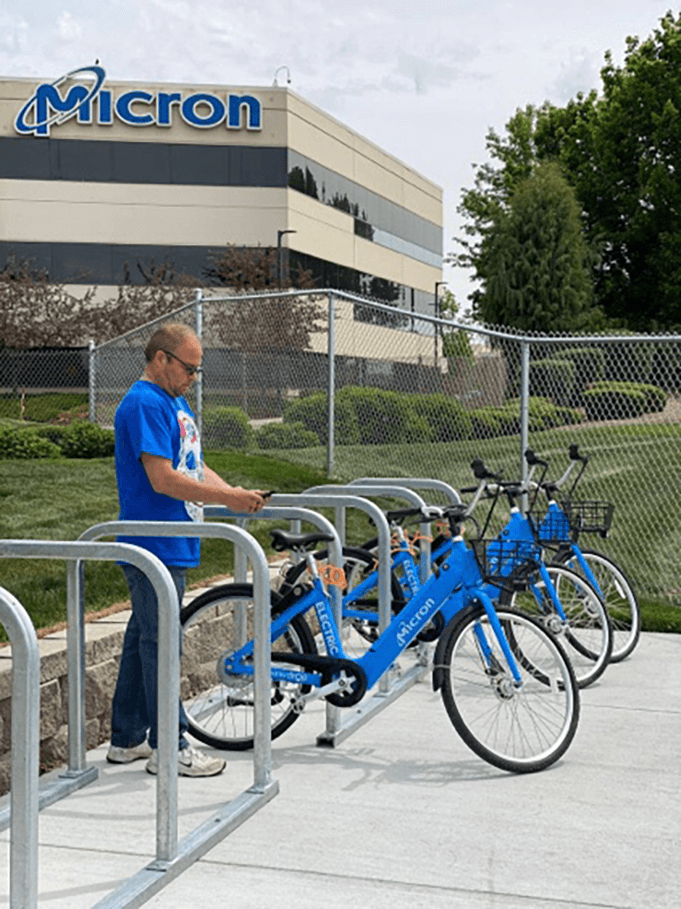 Blue Butterfly bike share bicycles parked at a Micron campus rack