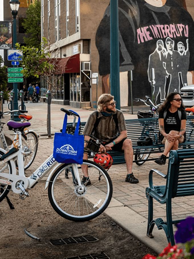 Butterfly bike share bicycles parked on a downtown street
